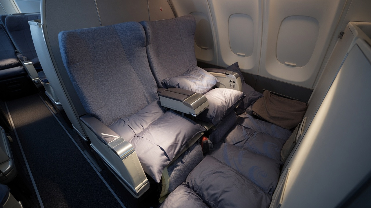 Traveler Turns Business Class Floor Into A Lie-Flat Bed — But This Isn’t A Normal Airline Cabin