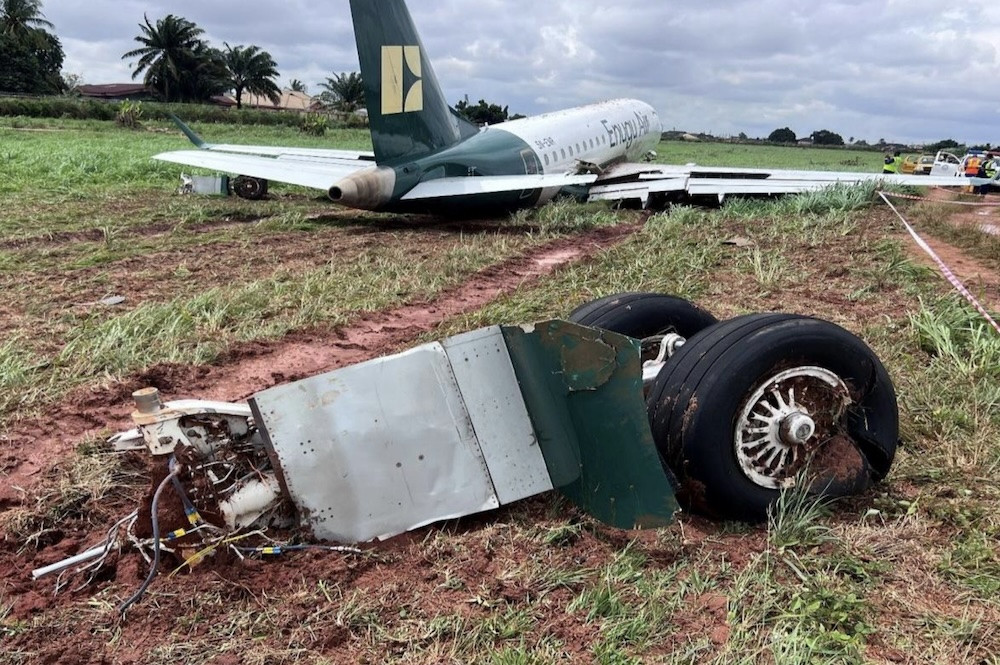 Enugu E170 overran after landing far down wet runway during tailwind approach